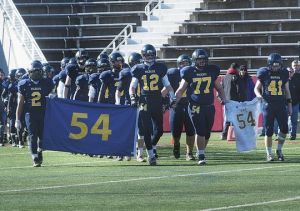 Members of the Shoreham-Wading River High School football team honor Tom Cutinella after his football-related death this season.(Photo: Robert O'Rourk, Niverhead News-Review)